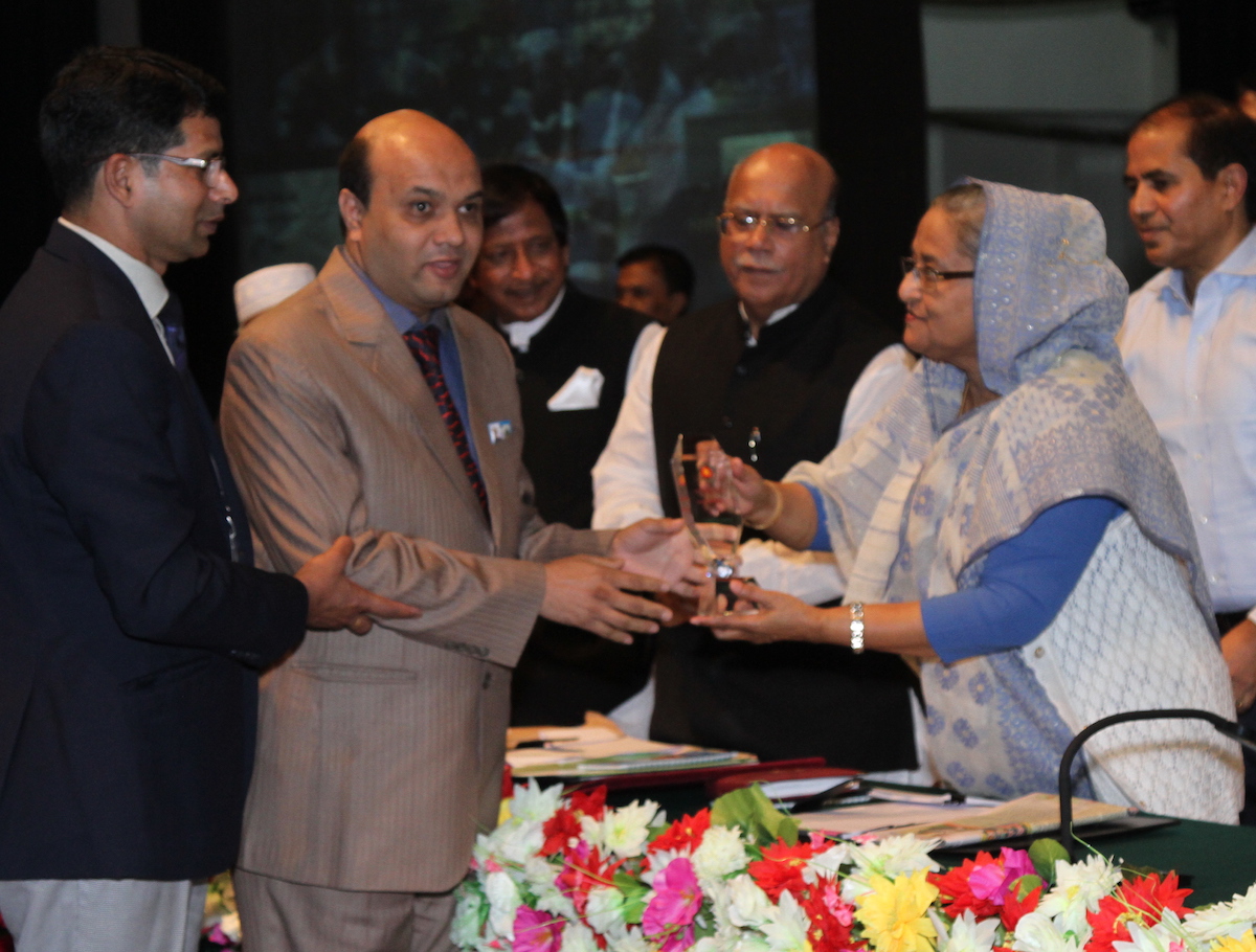 Bhattacharjee receiving his award from Bangladesh PM Sheikh Hasina.