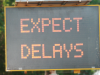 Street safety sign showing 'Expect Delays'