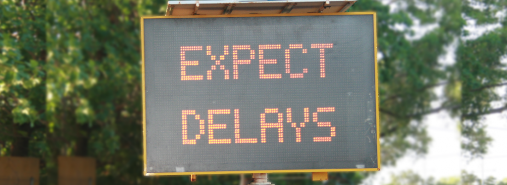 Street safety sign showing 'Expect Delays'