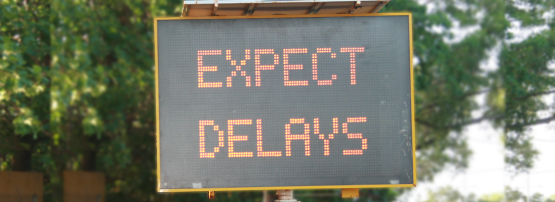 Street safety sign showing 'Expect Delays'