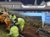 Fibre Optic cable being laid in a trench, with an ODTR meter