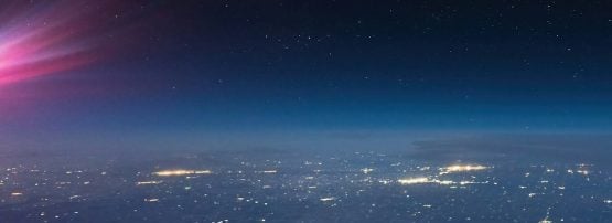 A view of a city lit up at night time.