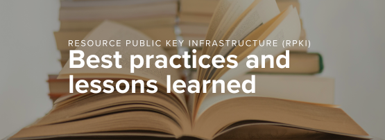 A white book on a brown wooden table.