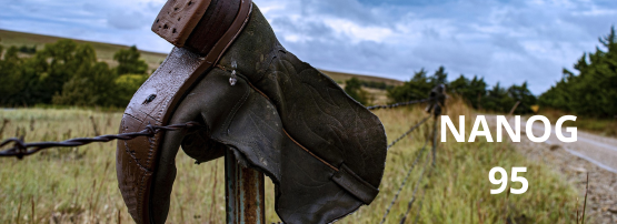 A cowboy boot on a fence post.