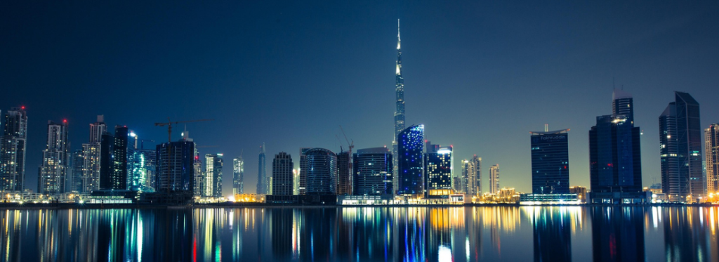 A city skyline at night time.