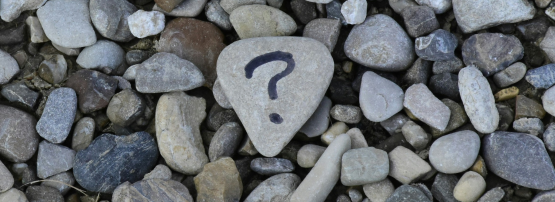 A question mark drawn on a rock.
